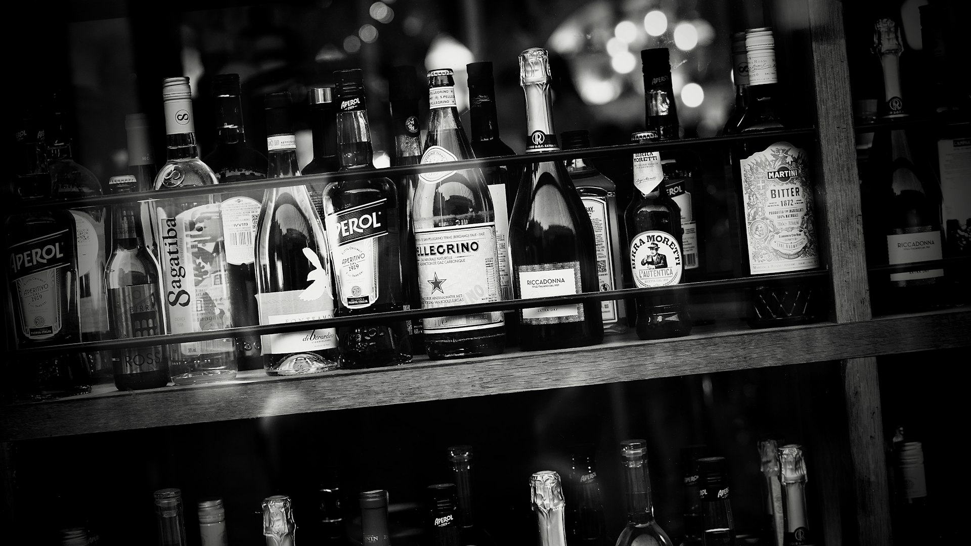 a shelf filled with lots of bottles of alcohol